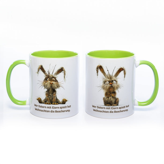 Motiv - Tasse mit Spruch und Hase: Wer Ostern mit Eiern spielt hat Weihnachten die Bescherung.- spülmaschinenfest
